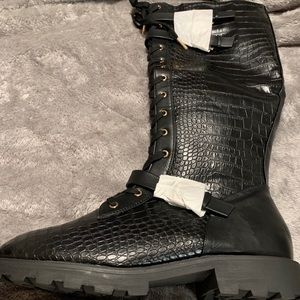 Black lace up combat knee boot.